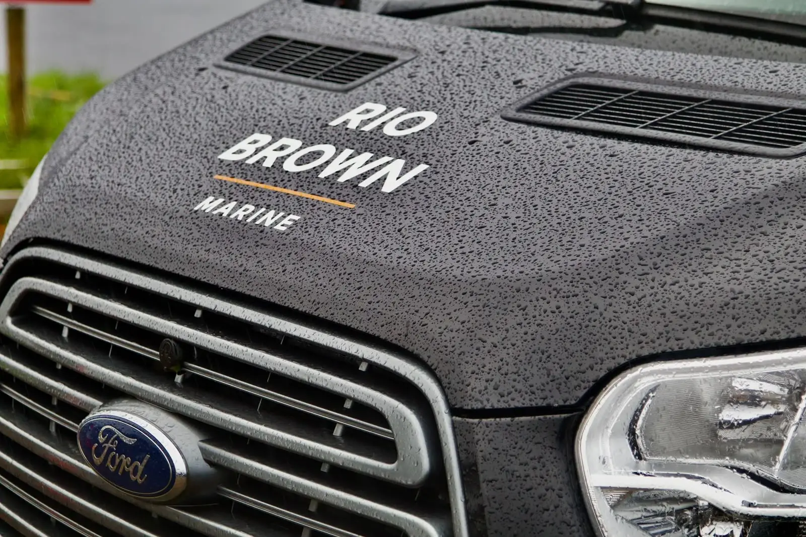 Rain-beaded bonnet of the Rio Brown Marine van